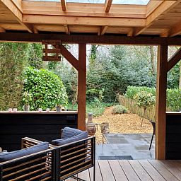 Enjoy the peace and quiet on the veranda of Holiday Home in Epe, Veluwe, Gelderland, overlooking the green garden and surrounding nature.