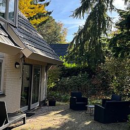 Geniet van de rust op het terras van Huisje in Epe, een vakantiehuis op de Veluwe in Gelderland, omringd door weelderige natuur.