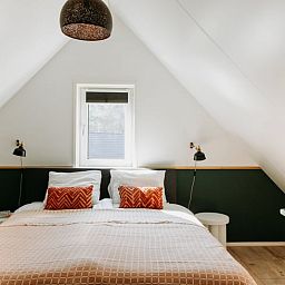 Bright bedroom in Holiday Home in Nunspeet, Veluwe, with a comfortable double bed and modern furnishings.