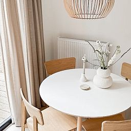 Stylish dining area in Cottage in Nunspeet, Veluwe, Gelderland with modern wooden furniture and views of nature.