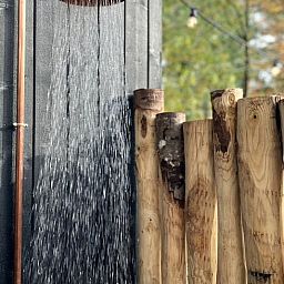 Refreshing outdoor shower at cottage in Nunspeet, Veluwe, Gelderland, ideal for a summer refresher.