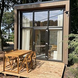 Wooden terrace at Holiday home in Lieren, surrounded by Veluwe forests.