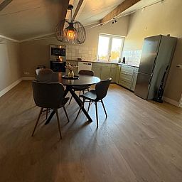 Cozy kitchen and dining area in Cottage in Schildwolde, Northeast Groningen, ideal for a relaxing stay.