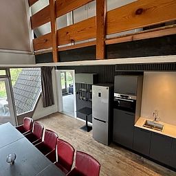 Modern kitchen and dining area in Holiday home in Stramproy, an attractive vacation home in Central Limburg, ideal for a relaxing stay.