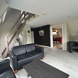 Stylish living room of Holiday Home in Stramproy, Central Limburg, with modern furnishings and comfortable seating area for relaxation.