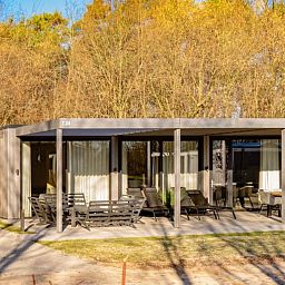 Enjoy the serene nature surrounding Bos Villa, a vacation home for 8 in Maasbree, Limburg, with spacious terrace and modern furnishings.