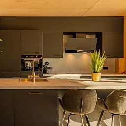 Modern kitchen of Bos Villa in Maasbree, North Limburg. Stylish vacation home for 8 with luxury amenities and contemporary design.
