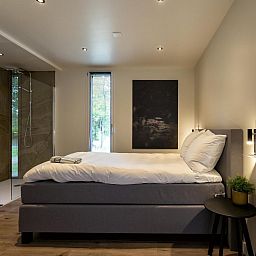 Comfortabele slaapkamer in Bos Cottage, Maasbree, Noord Limburg, ideaal vakantiehuis voor 6 personen met luxe voorzieningen.