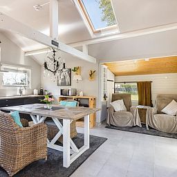 Modern bathroom in Holiday Home in Heythuysen, North Limburg, with sleek white tiles and stylish shower.