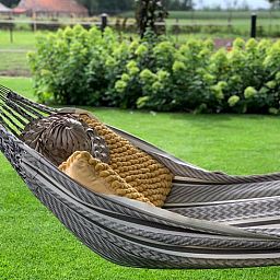Ontspannen in een hangmat bij Vakantiehuisje in Heythuysen, Noord Limburg, Limburg.