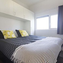 Comfortable bedroom in Module 6 persons vacation home Schin op Geul, South Limburg with modern decor and lots of light.