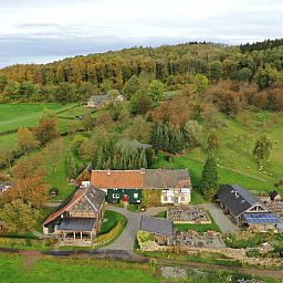 Aerial view of Holiday home in Vijlen, South Limburg, surrounded by green hills and nature, perfect for a relaxing stay.
