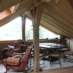 Cozy interior of Holiday Home in Vijlen, South Limburg, with wooden beams and views of beautiful nature.