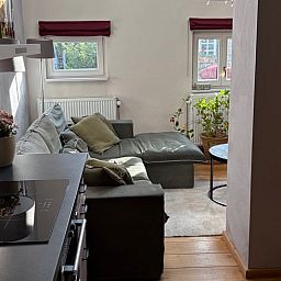 Cozy living room in a vacation home in Beutenaken, South Limburg, with a comfortable seating area and plenty of natural light for a relaxing stay.