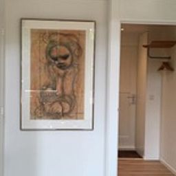 Interior of Holiday Home in Eersel, Kempen, North Brabant with art on the wall and an open door to the hallway.