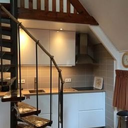 Modern kitchen in Holiday home in Eersel, North Brabant, with wooden staircase and cozy interior for a comfortable stay.