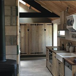 Cozy interior of vacation home in Oisterwijk, Heart of Brabant, with rustic wooden kitchen and cozy atmosphere.