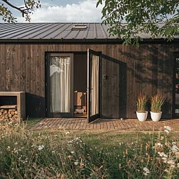 Charming entrance to Holiday home in Chaam, North Brabant with wooden facade and veranda in Heart of Brabant.