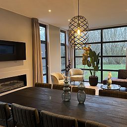 Stylish living room of the Detached house in Kaatsheuvel, Heart of Brabant, overlooking the green garden through large windows.
