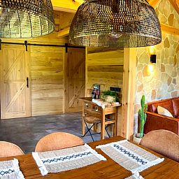 Cozy interior of Holiday Home in Ledeacker, northeast Brabant, with wooden interior and comfortable sitting area.