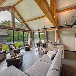 Modern living room of Villa Bianco vacation home in Alphen, North Brabant.