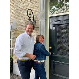 Gasten openen de voordeur van Huisje in Moerstraten, een charmant vakantiehuis in West Brabant, Noord Brabant.