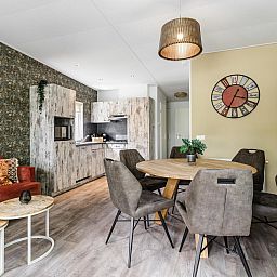 Cozy interior of Beach House sleeps 6 in Julianadorp, North Sea Coast, with modern kitchen and comfortable seating area.