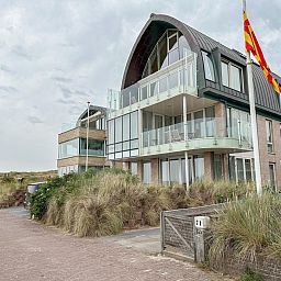 Ferienhaus "Krab aan Zee" in Egmond aan Zee, Nordholland, mit moderner Architektur und Blick auf die Duenen entlang der Nordseekueste.