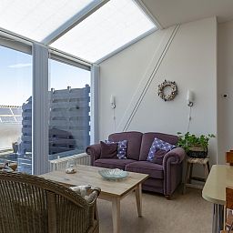 Bright living room in Dorpsplein 23E Callantsoog vacation home, with comfortable furniture, North Holland.