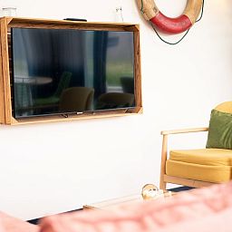 Comfortable sitting area with television in Callants Comfort 4, vacation home in Callantsoog.