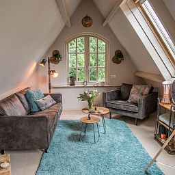 Gezellige woonkamer in Casa Allegria, Bergen, met moderne meubels en veel natuurlijk licht voor ultieme ontspanning.