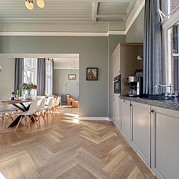 Stijlvolle keuken en eetkamer in vakantiehuis Groot Weeshuis, Enkhuizen, Noord-Holland, met ruime inrichting en veel natuurlijk licht.