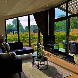 Cozy living room of detached house in Enkhuizen, located on the IJsselmeer coast, North Holland, overlooking the green surroundings.