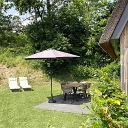 Back of the 6-person Dune Lodge with Charging Point in Schoorl, North Holland. Vacation home with modern design and nature.