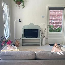 Bright interior of Holiday Home in Driehuizen with modern furnishings and access to garden, North Holland.