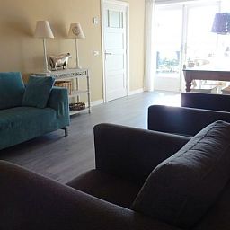 Stylish living room of Holiday Home in Weesp, Amsterdam eo, North Holland with comfortable seating area and plenty of natural light.