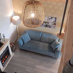 Cozy living room of Holiday home in Weesp, Amsterdam e.o., North Holland with cozy fireplace and comfortable sofa.