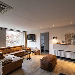 Cozy living room in Holiday Home in Den Ham, Twente, with comfortable seating area and views of the nature of Overijssel.