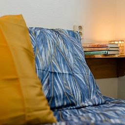 Cozy bedroom in Cottage in Den Ham, Twente, Overijssel with atmospheric lighting and comfortable beds.