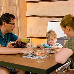 Family enjoys a game on the terrace of Huisje in Den Ham, a vacation home in green Twente, Overijssel.