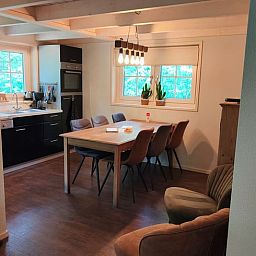 Cozy dining room of Holiday Home in de Lutte, Twente, with modern kitchen and view of green surroundings in Overijssel.