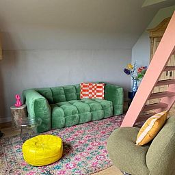 Open space with wooden floor and stairs in Cottage in Rijssen, vacation accommodation in Twente, Overijssel.