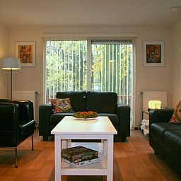 Cozy living room of Holiday Home in Haaksbergen, Twente with comfortable seating area and views of the nature of Overijssel.