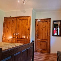 Cottage in Denekamp, vacation home in Twente, Overijssel, bedroom with wooden cabinets and doors.