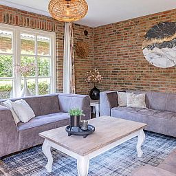 Cozy living room of Holiday home in Losser, Twente. Comfortable sitting area with natural light and stylish decor.