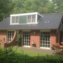 Charmantes Ferienhaus in Holten, Overijssel, umgeben von viel Gruen mit einer einladenden Terrasse zum Entspannen in der Natur.