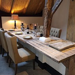 Cozy dining room in Holiday home in Nieuwleusen, Salland, with wooden table in Overijssel.