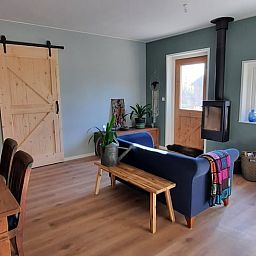 Cozy living room of Holiday Home in Wesepe, Salland with wood stove and wooden interior.