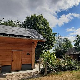 Sustainable Holiday Home in Wesepe, Overijssel with solar panels and rural garden.