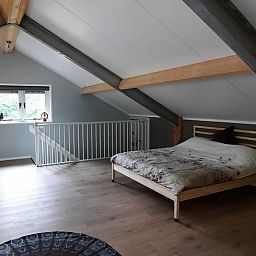 Spacious bedroom in Holiday Home in Wesepe, Salland with wooden beams and serene atmosphere.